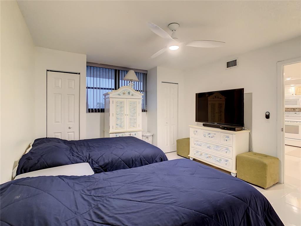 18304 Gulf Boulevard, Unit 116 Redington Shores, FL 33708 - Photo 33 of 51 a bedroom with a bed and a flat screen tv