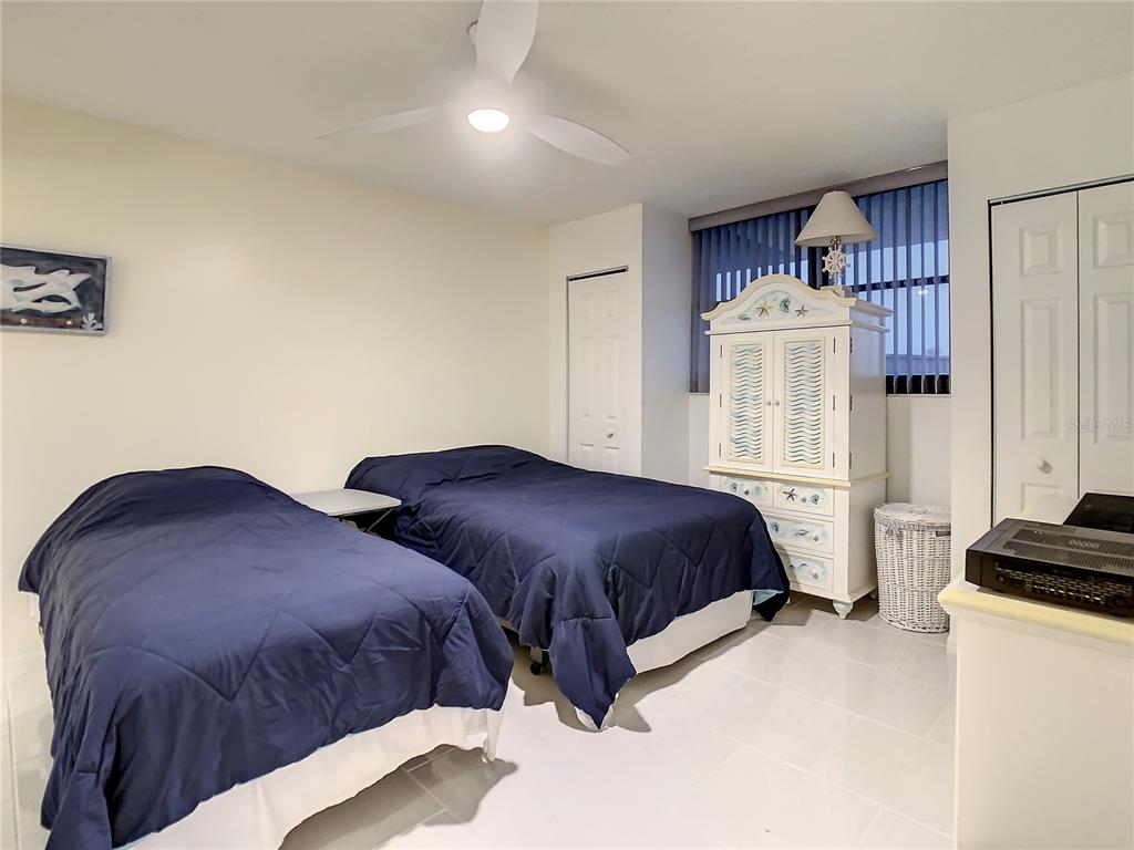 18304 Gulf Boulevard, Unit 116 Redington Shores, FL 33708 - Photo 34 of 51 a bedroom with two beds and a window