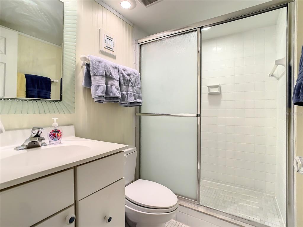 18304 Gulf Boulevard, Unit 116 Redington Shores, FL 33708 - Photo 36 of 51 a bathroom with a sink toilet and shower