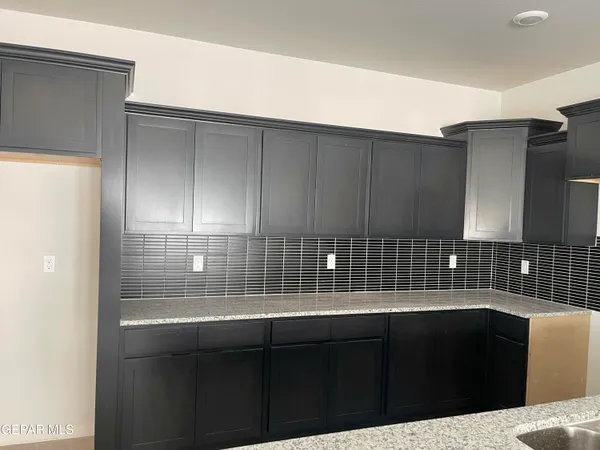 a kitchen with a sink and cabinets