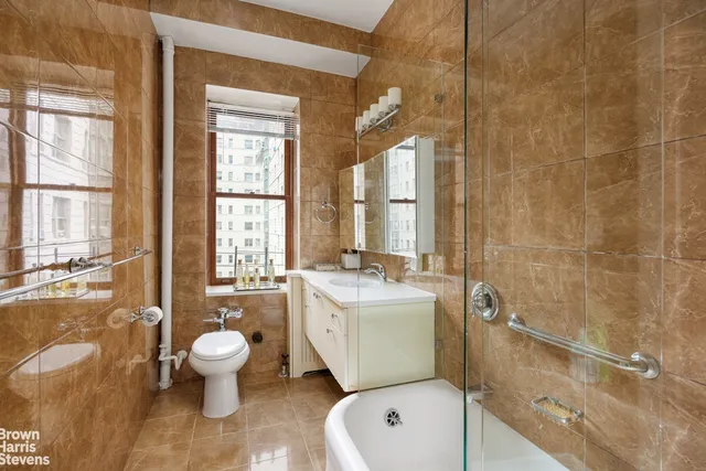 a bedroom with a bed flat screen tv and a window