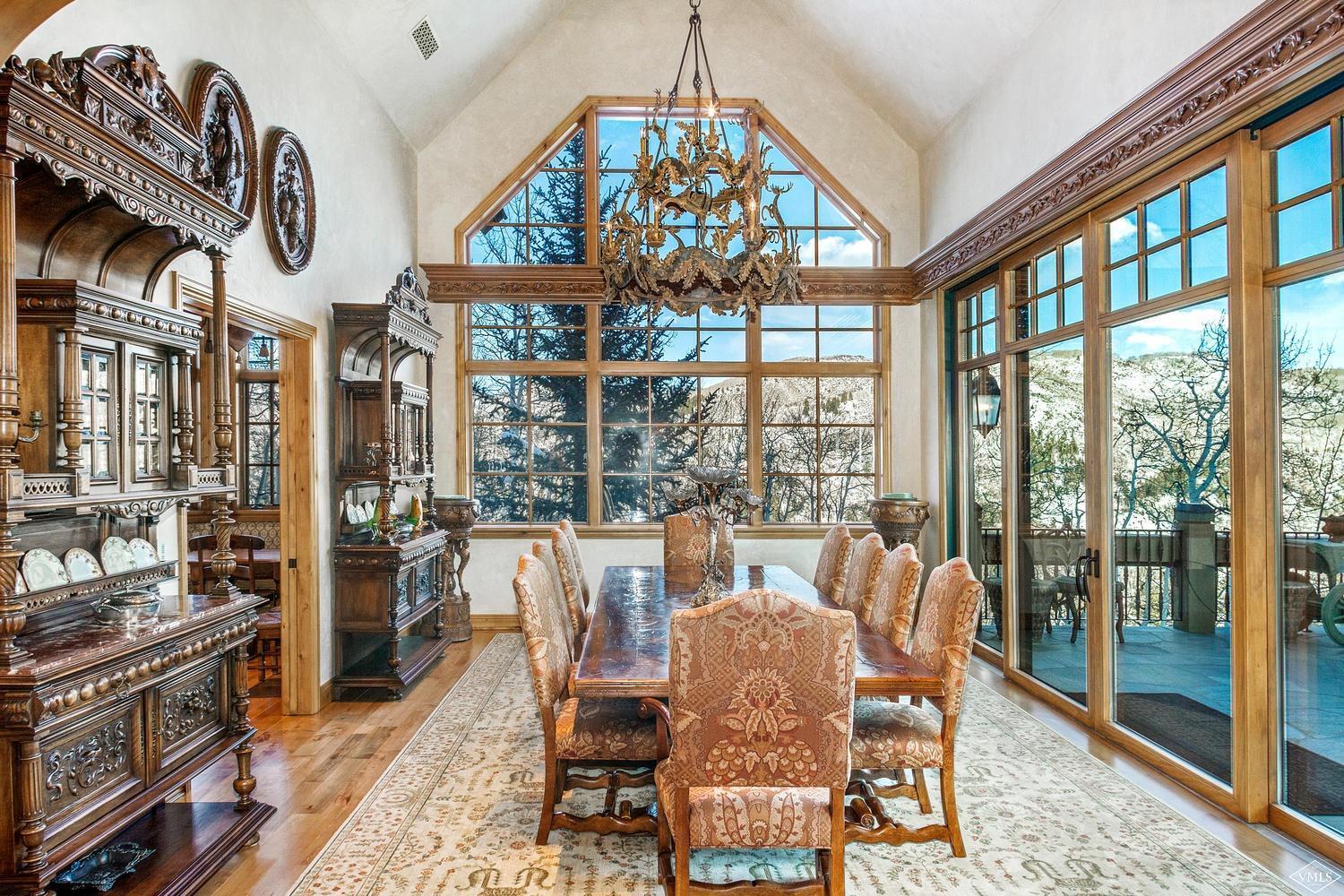 22 Strawberry Park Road Beaver Creek, CO 81620 - Photo 12 of 25 a view of a dining room with furniture a chandelier and wooden floor