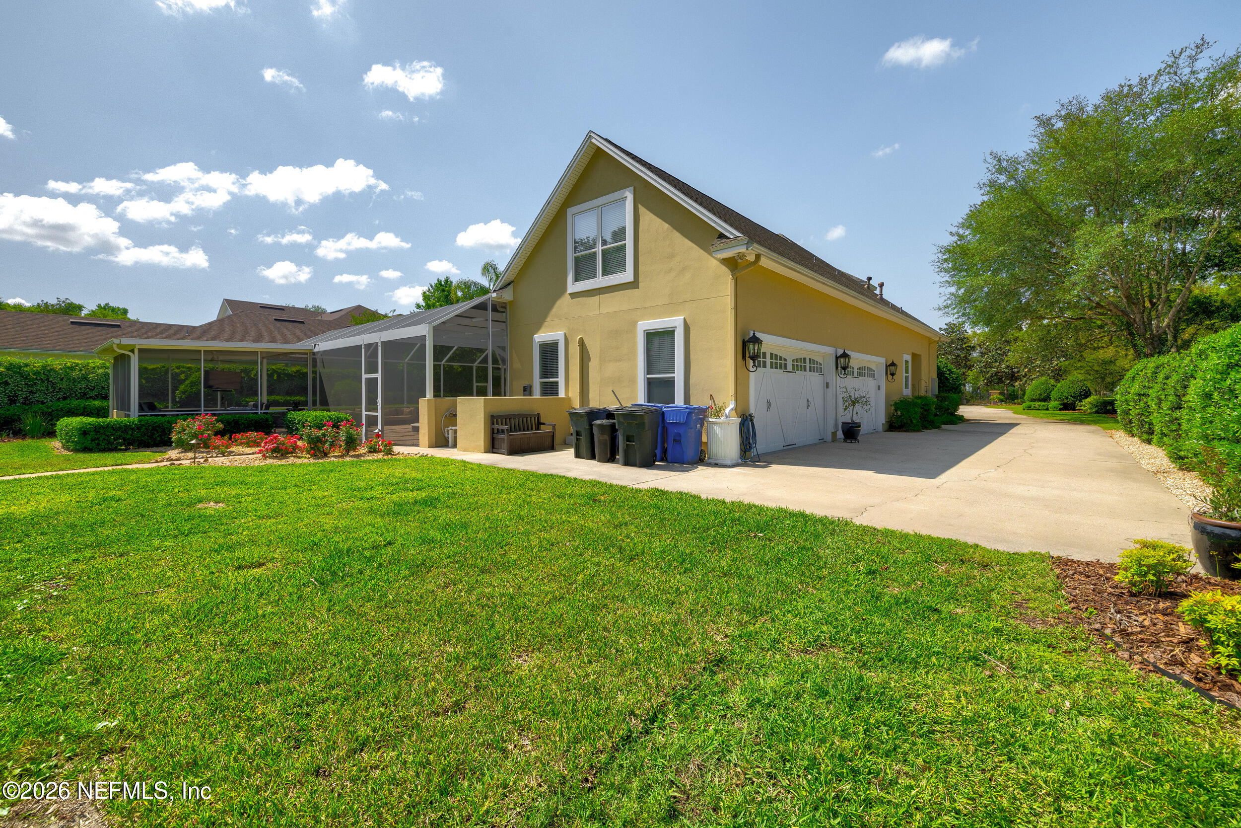 3225 Bishop Estates Road St. Johns, FL 32259 - Photo 79 of 90 a front view of a house with a yard and potted plants