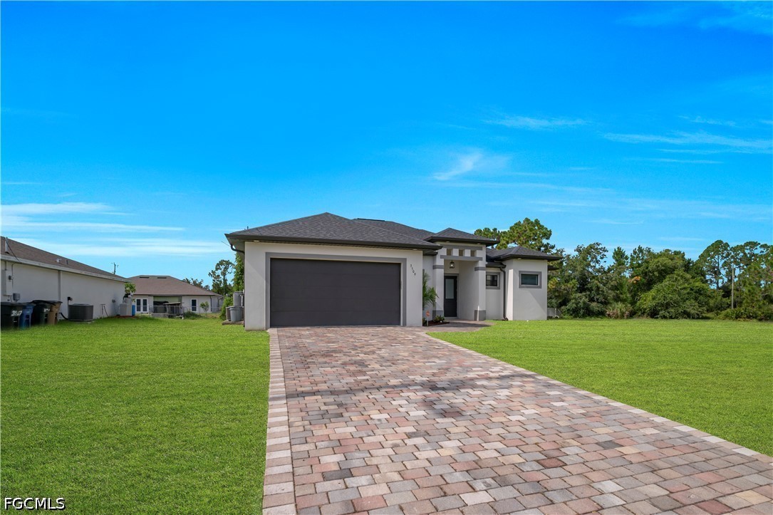 3509 38th Street Southwest Lehigh Acres, FL 33976 - Photo 7 of 47 a front view of a house with yard