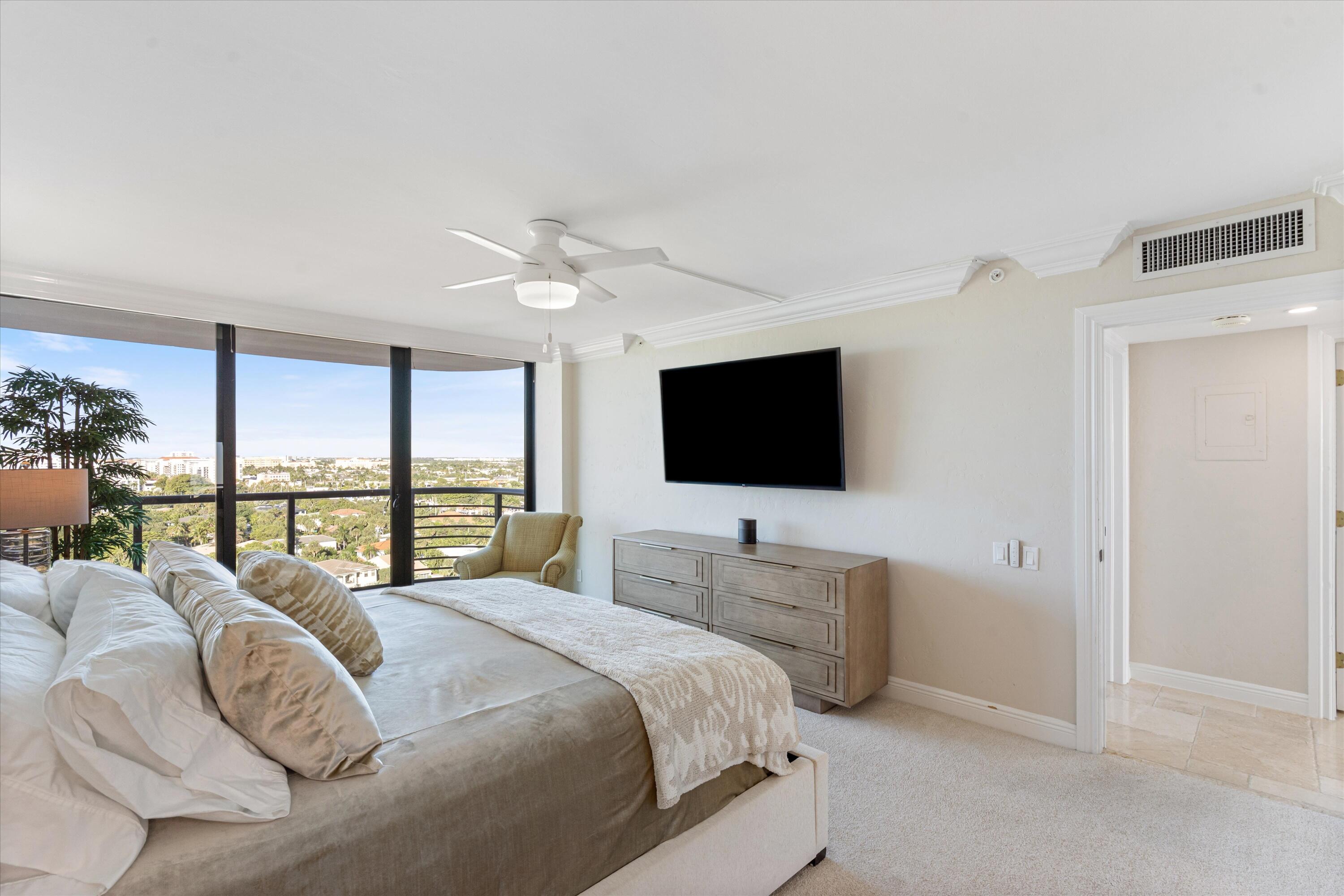 250 South Ocean Boulevard, Unit 14E Boca Raton, FL 33432 - Photo 11 of 27 a bedroom with a bed and a flat screen tv