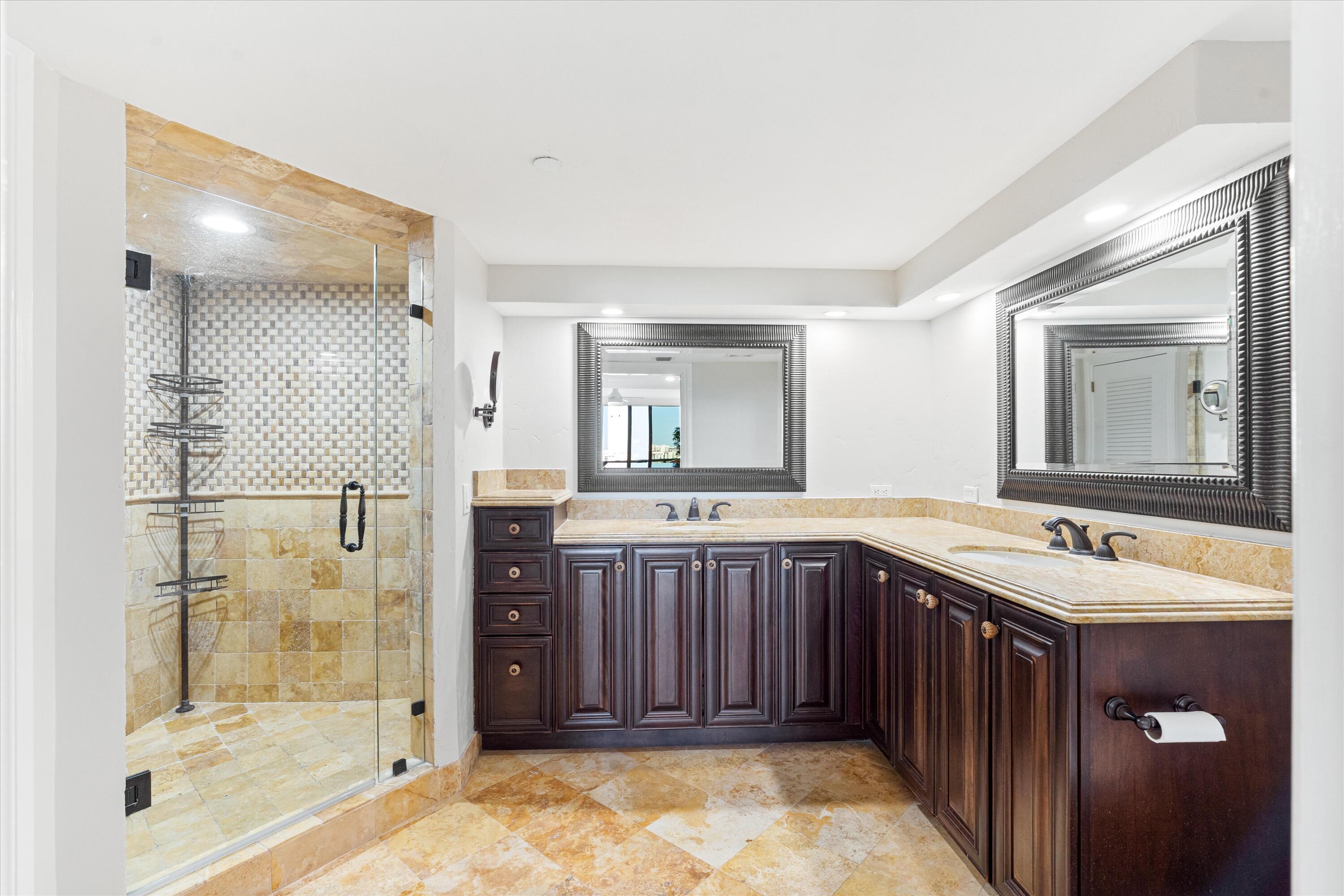 250 South Ocean Boulevard, Unit 14E Boca Raton, FL 33432 - Photo 14 of 27 a bathroom with a sink mirror and shower