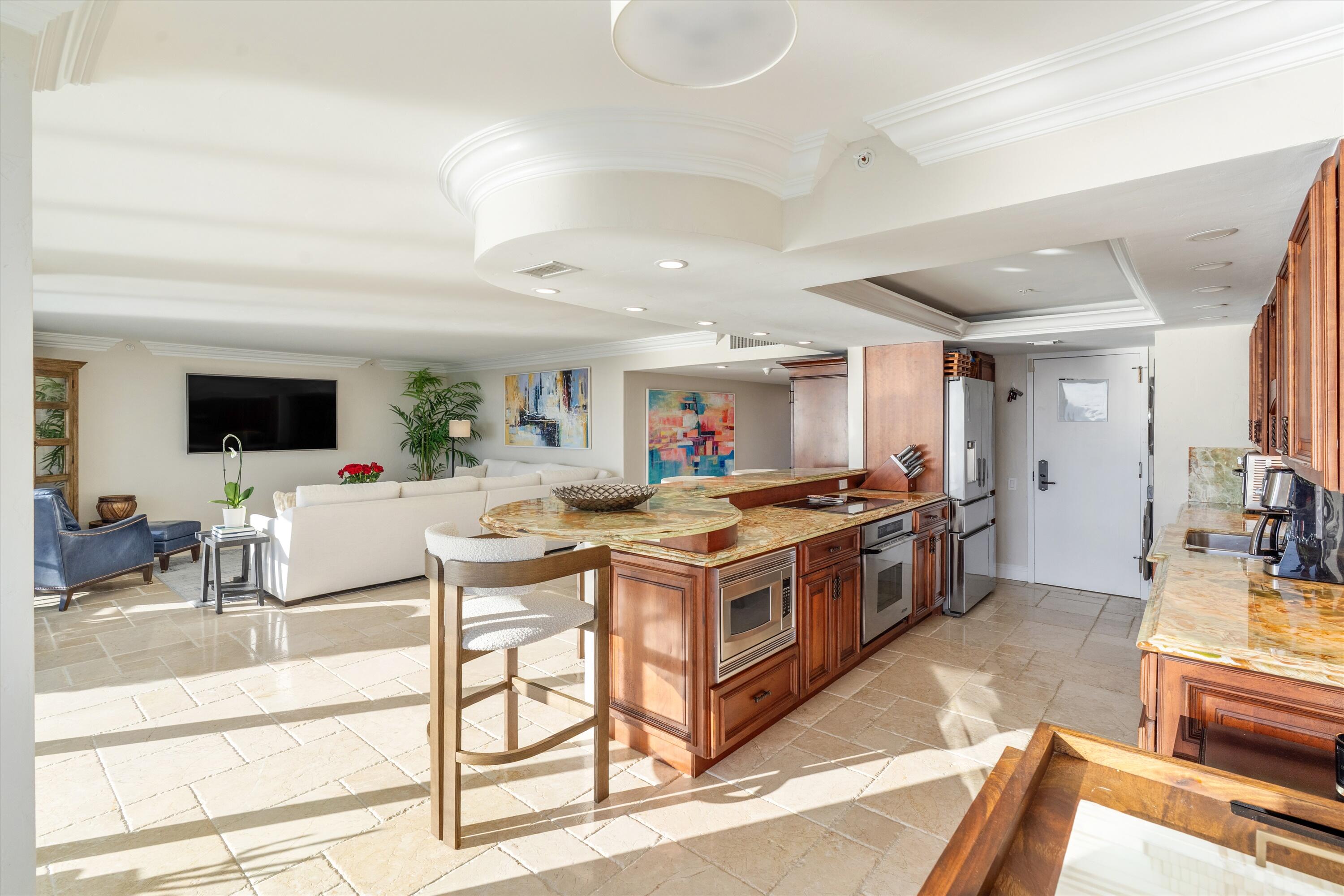 250 South Ocean Boulevard, Unit 14E Boca Raton, FL 33432 - Photo 5 of 27 a kitchen with stainless steel appliances kitchen island granite countertop a stove and a sink