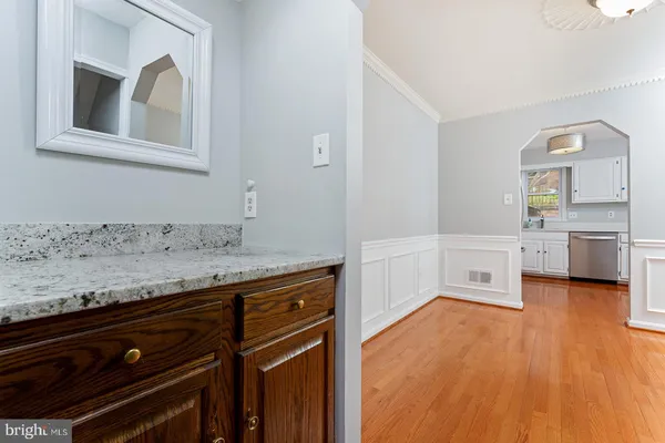 a spacious bathroom with a granite countertop sink and a mirror