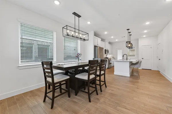 a view of a dining room with furniture and wooden floor