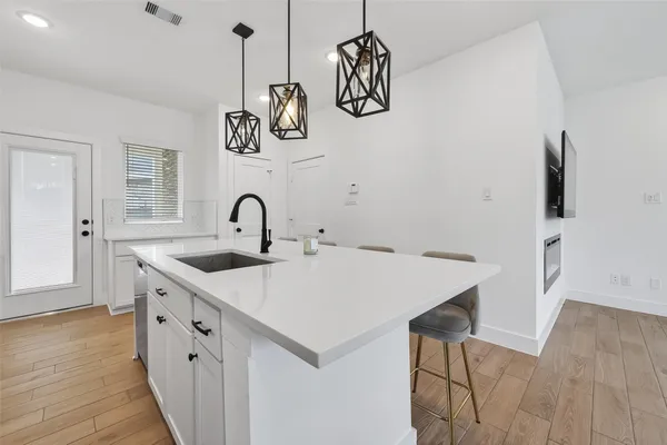 a kitchen with a sink and a refrigerator