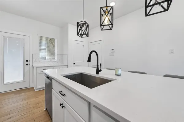 a kitchen with a sink and cabinets