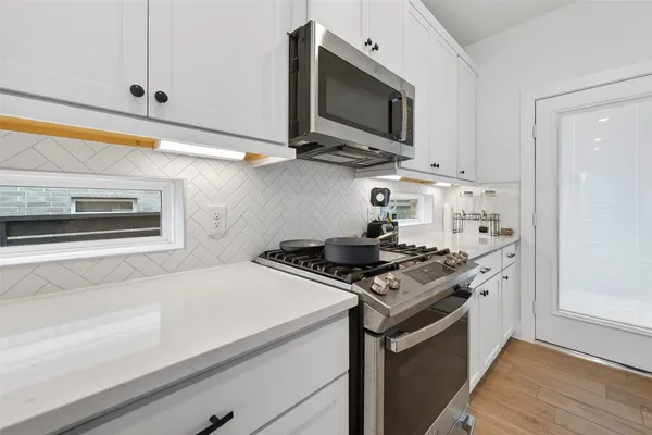 a kitchen with a stove and a microwave