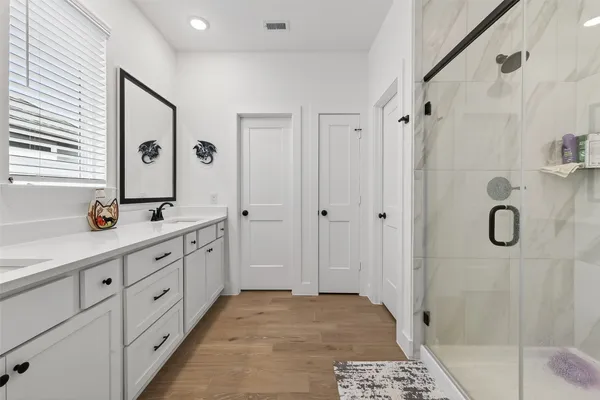 a bathroom with a double vanity sink and mirror
