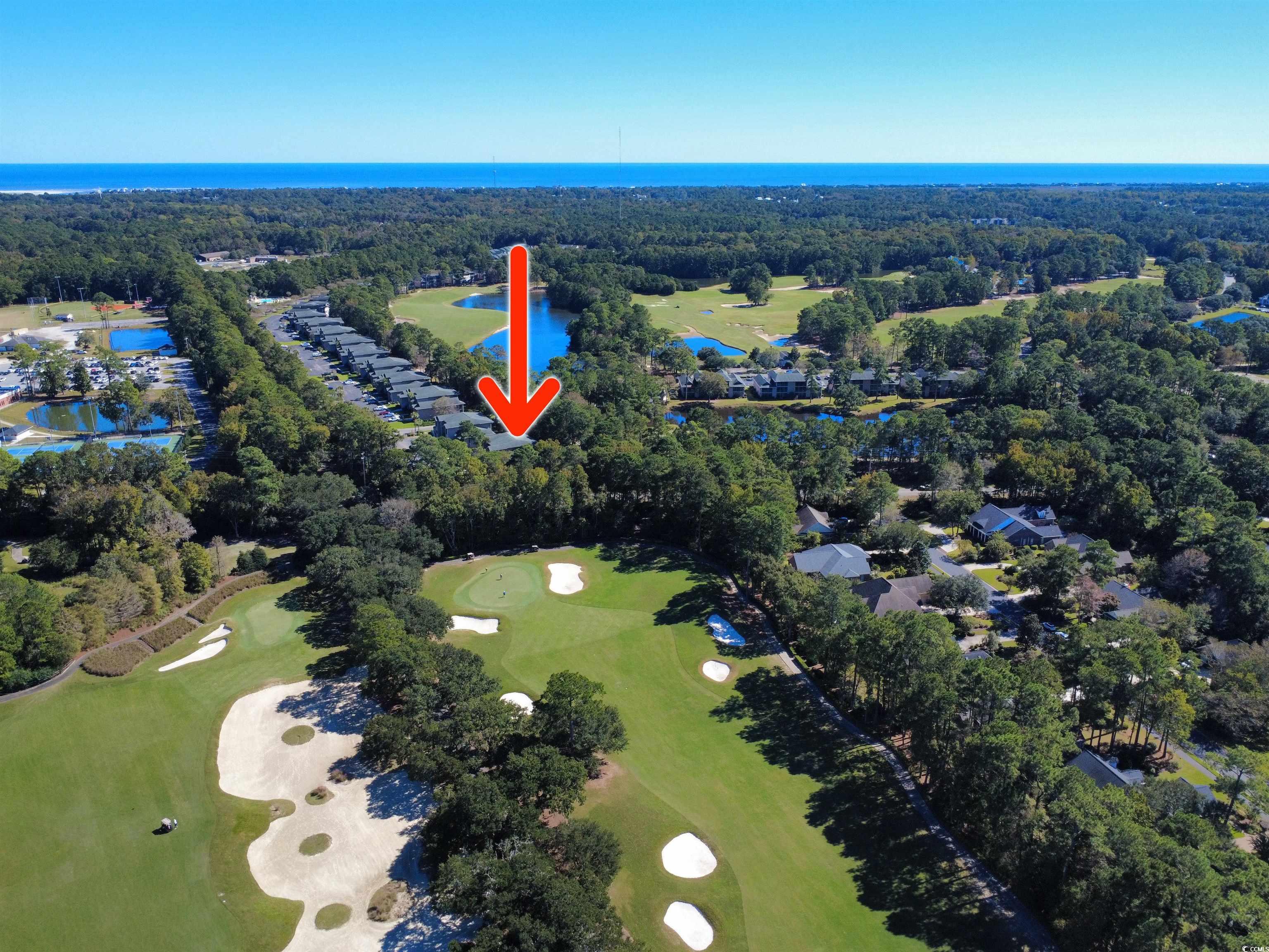 227 Pinehurst Lane, Unit 6D Pawleys Island, SC 29585 - Photo 12 of 39 Aerial overview of property's location with a large body of water, a golf course, and nearby suburban area