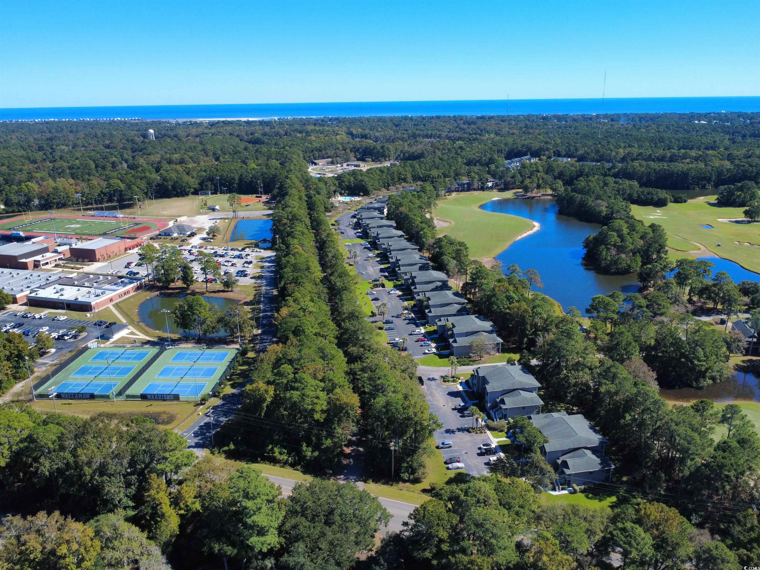 227 Pinehurst Lane, Unit 6D Pawleys Island, SC 29585 - Photo 13 of 39 Bird's eye view of a nearby body of water and a heavily wooded area