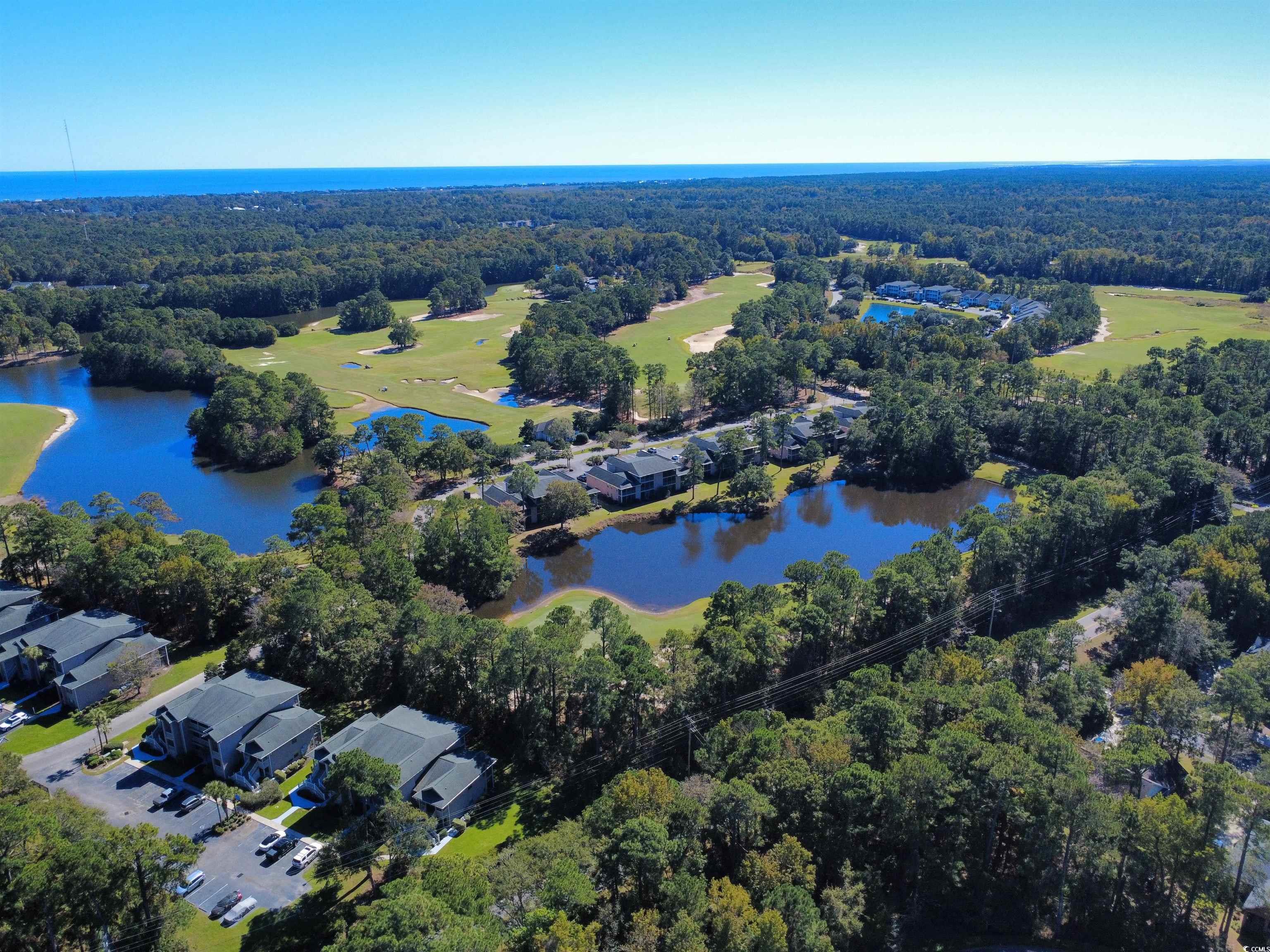227 Pinehurst Lane, Unit 6D Pawleys Island, SC 29585 - Photo 18 of 39 Aerial overview of property's location with a large body of water and nearby suburban area