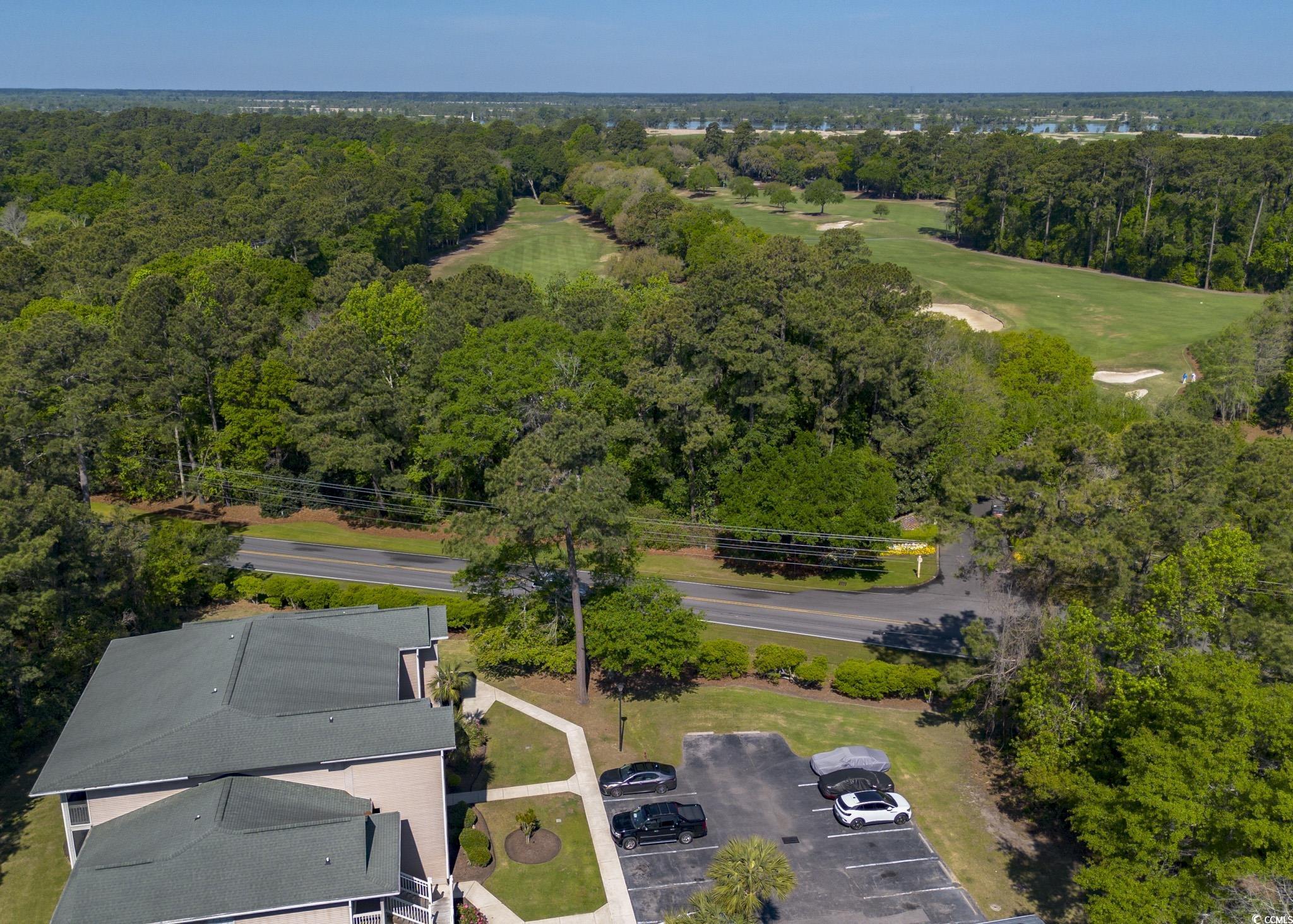 227 Pinehurst Lane, Unit 6D Pawleys Island, SC 29585 - Photo 20 of 39 Drone / aerial view featuring a view of trees and golf course view