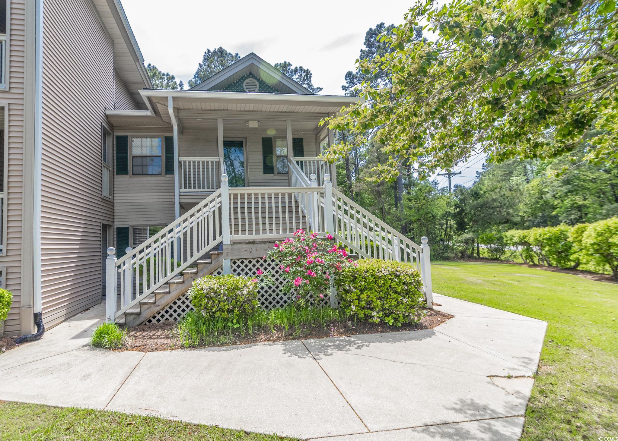 227 Pinehurst Lane, Unit 6D Pawleys Island, SC 29585 - Photo 2 of 39 Property entrance with a yard and a porch