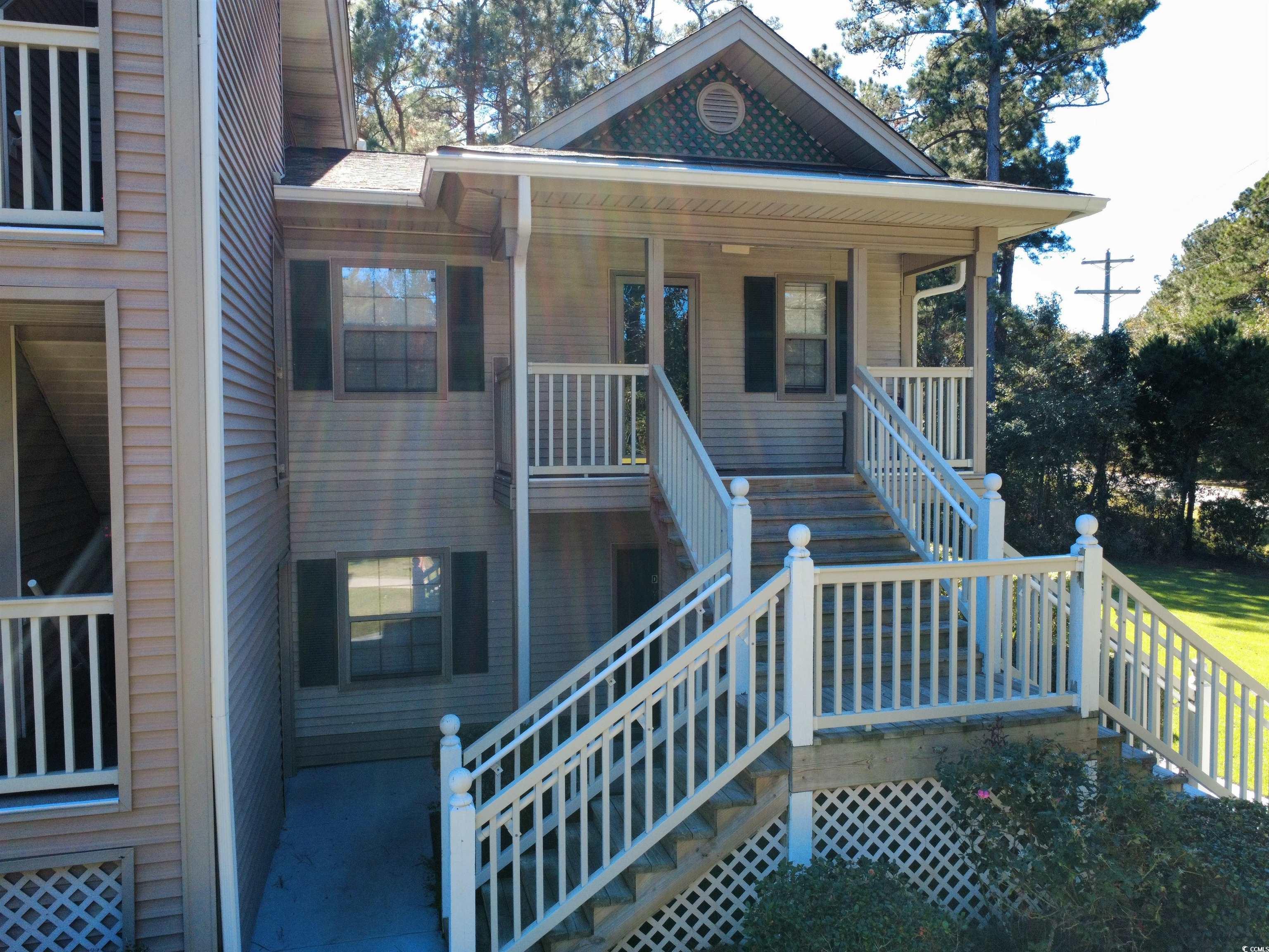 227 Pinehurst Lane, Unit 6D Pawleys Island, SC 29585 - Photo 21 of 39 View of exterior entry featuring covered porch