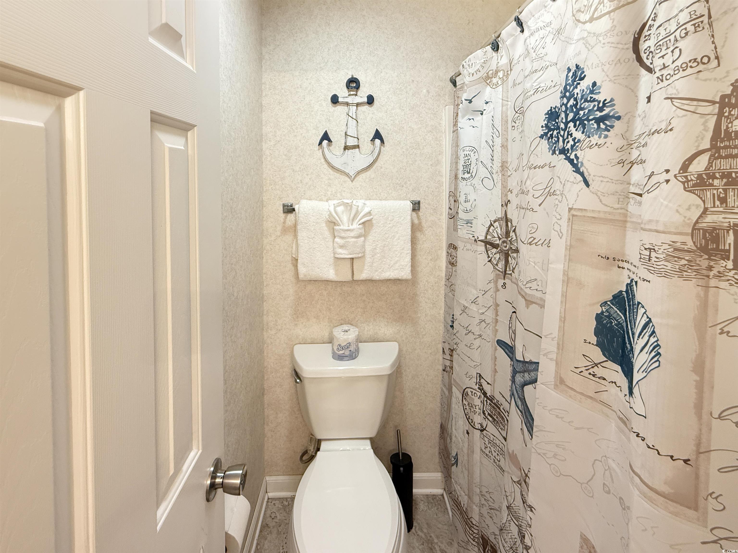 227 Pinehurst Lane, Unit 6D Pawleys Island, SC 29585 - Photo 23 of 39 Bathroom featuring a shower with curtain and wallpapered walls