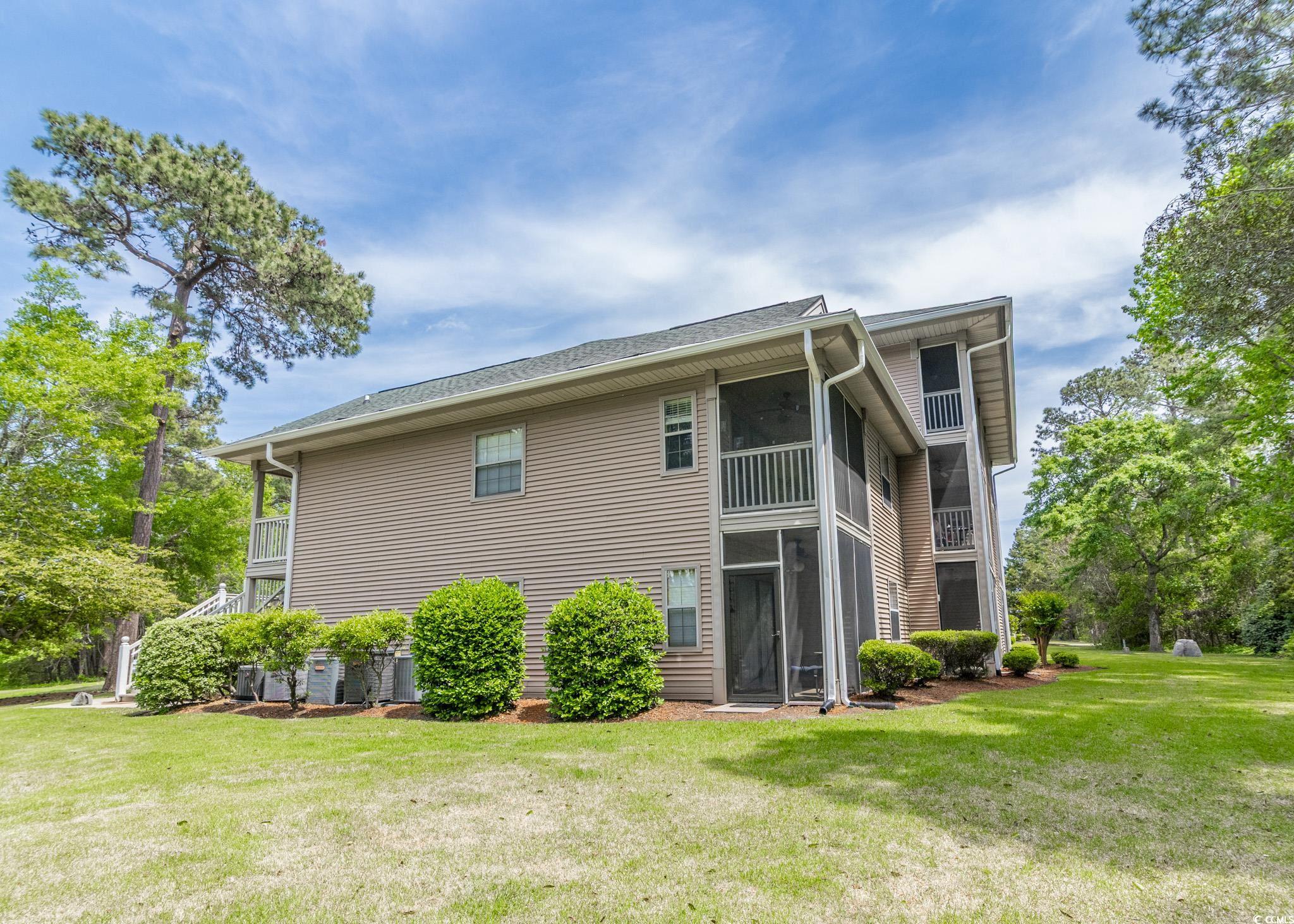227 Pinehurst Lane, Unit 6D Pawleys Island, SC 29585 - Photo 3 of 39 Exterior space featuring a lawn and a sunroom