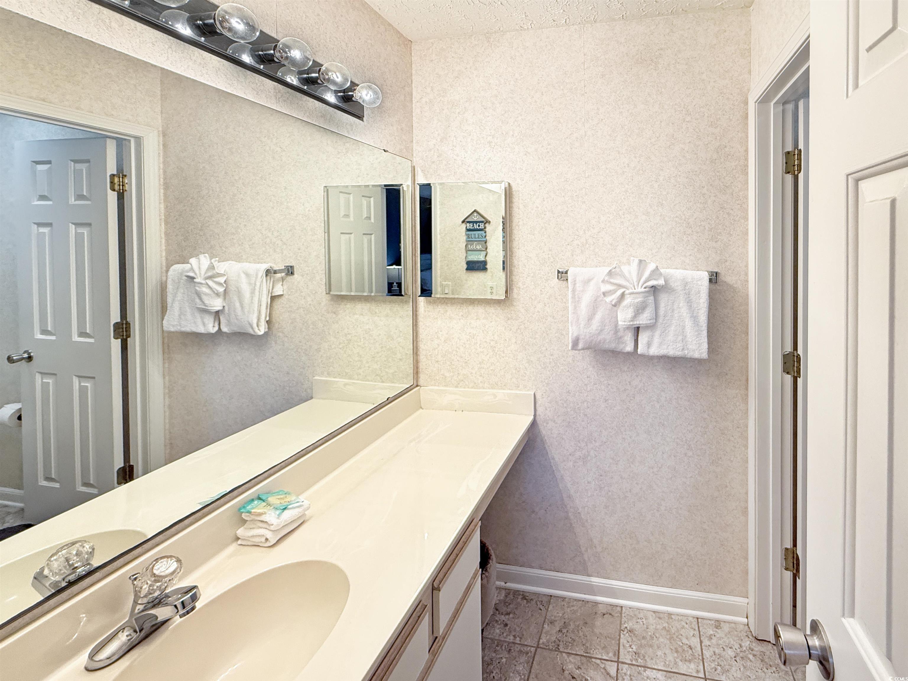 227 Pinehurst Lane, Unit 6D Pawleys Island, SC 29585 - Photo 32 of 39 Bathroom with vanity and light tile patterned floors