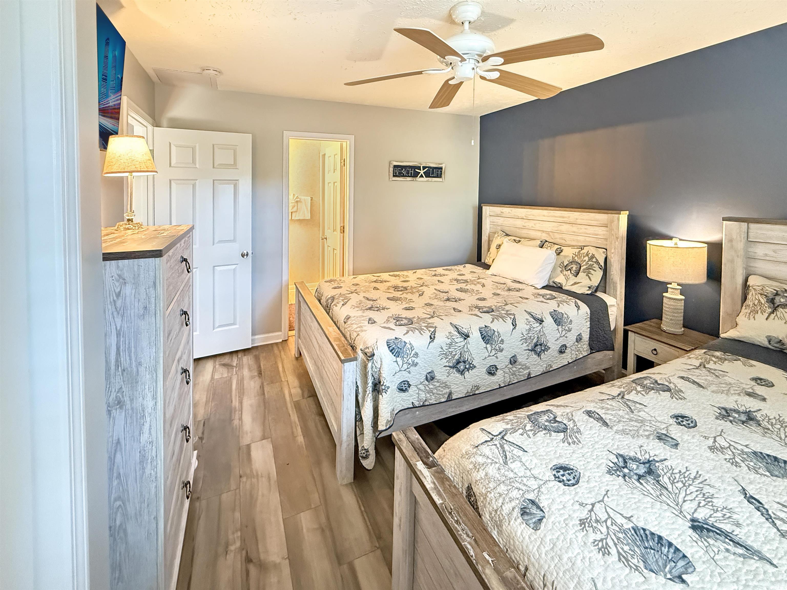 227 Pinehurst Lane, Unit 6D Pawleys Island, SC 29585 - Photo 34 of 39 Bedroom featuring light wood finished floors, ceiling fan, and a textured ceiling