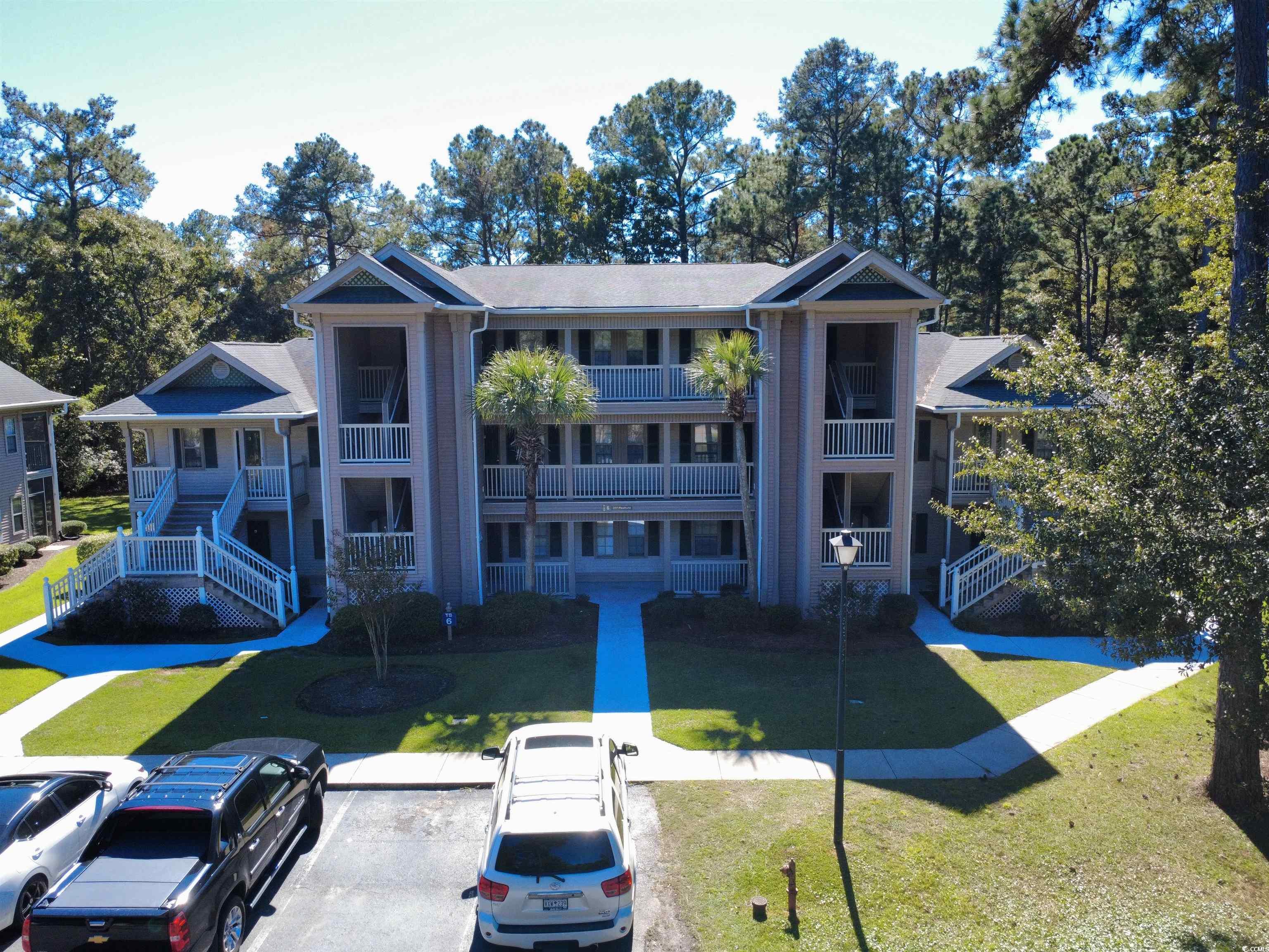227 Pinehurst Lane, Unit 6D Pawleys Island, SC 29585 - Photo 39 of 39 View of building exterior featuring stairway