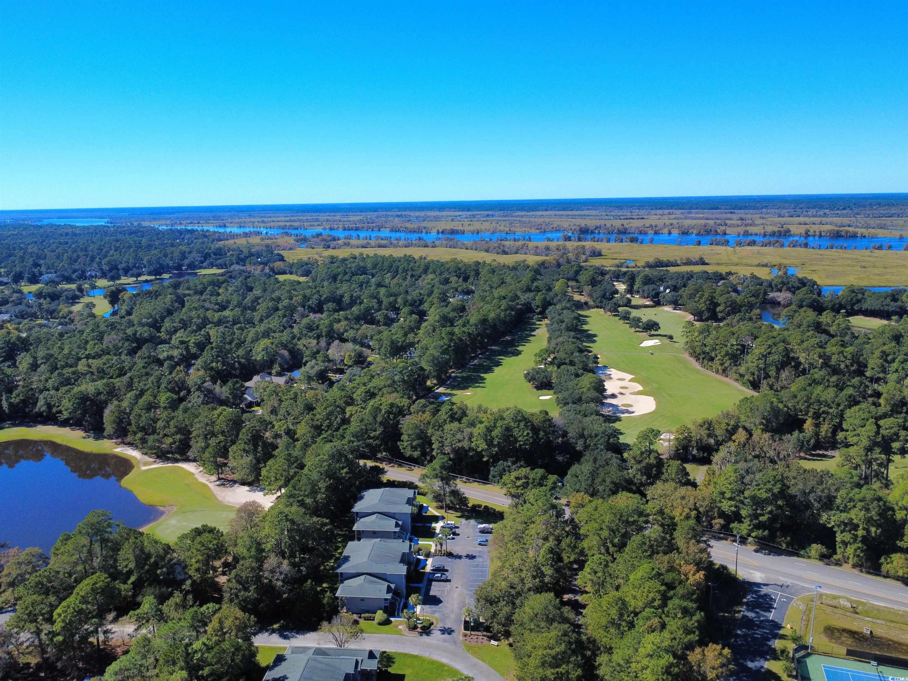 227 Pinehurst Lane, Unit 6D Pawleys Island, SC 29585 - Photo 9 of 39 Aerial view of property's location with a nearby body of water and a local golf course