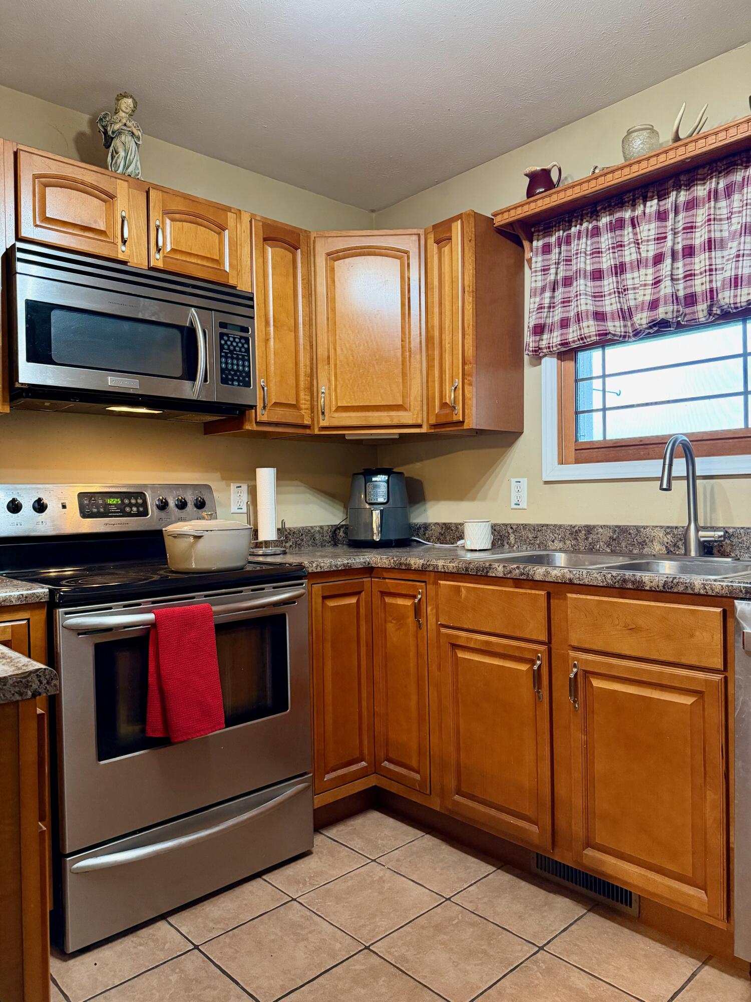 5850 West 600 North Winamac, IN 46996 - Photo 6 of 28 a kitchen with stainless steel appliances granite countertop a stove a sink and a microwave