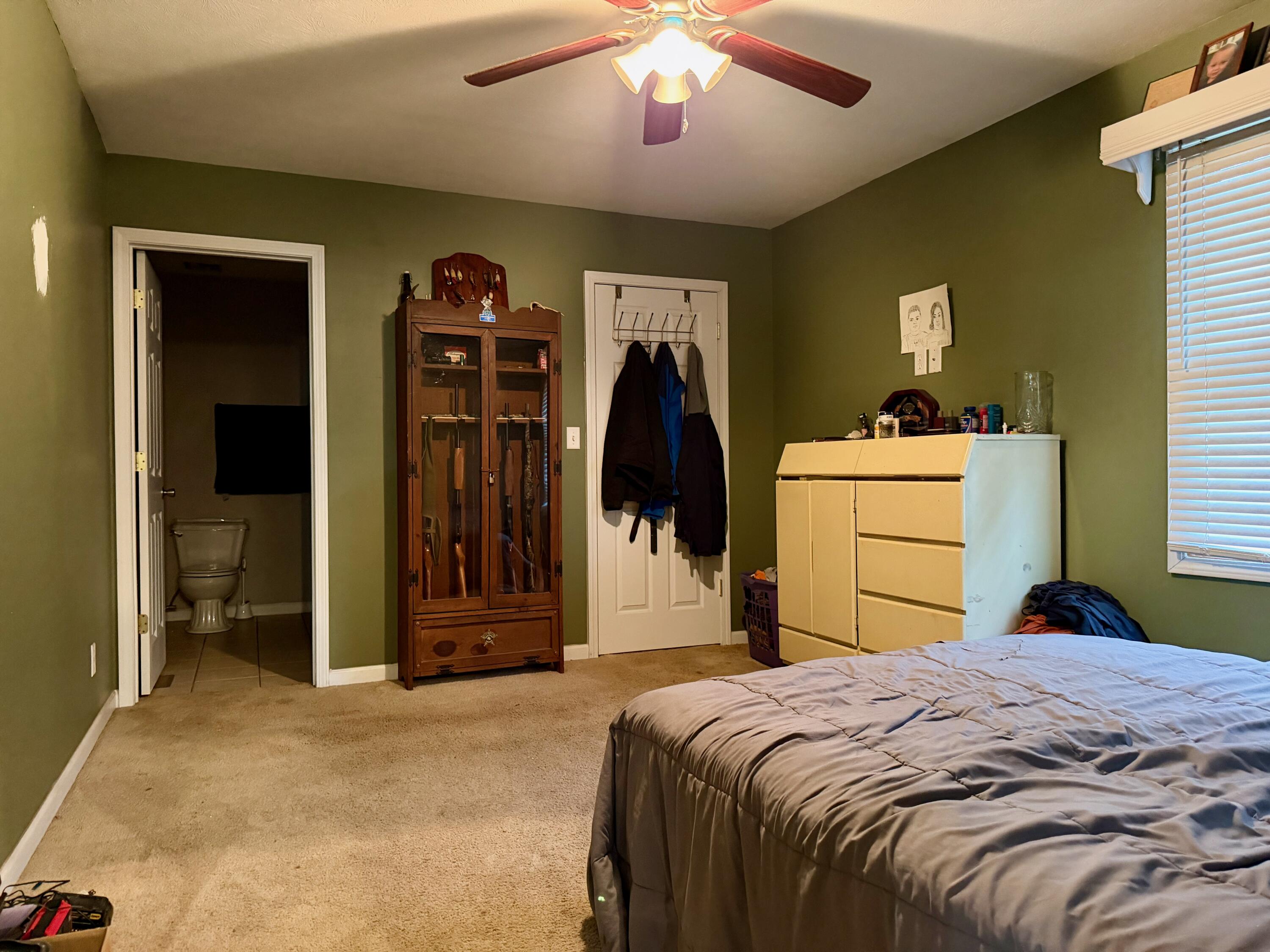 5850 West 600 North Winamac, IN 46996 - Photo 9 of 28 a bedroom with a bed and a chandelier