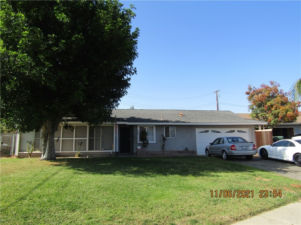 6385 Longhill Street Riverside, CA 92504 - Photo 1 of 1 a front view of a house with a garden and trees