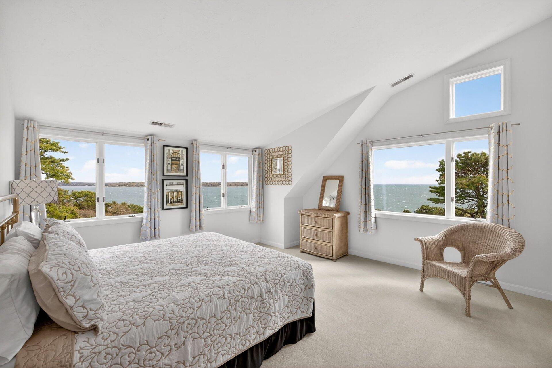 461 Wings Neck Road Pocasset, MA 02559 - Photo 23 of 42 a bedroom with a large bed and a large window
