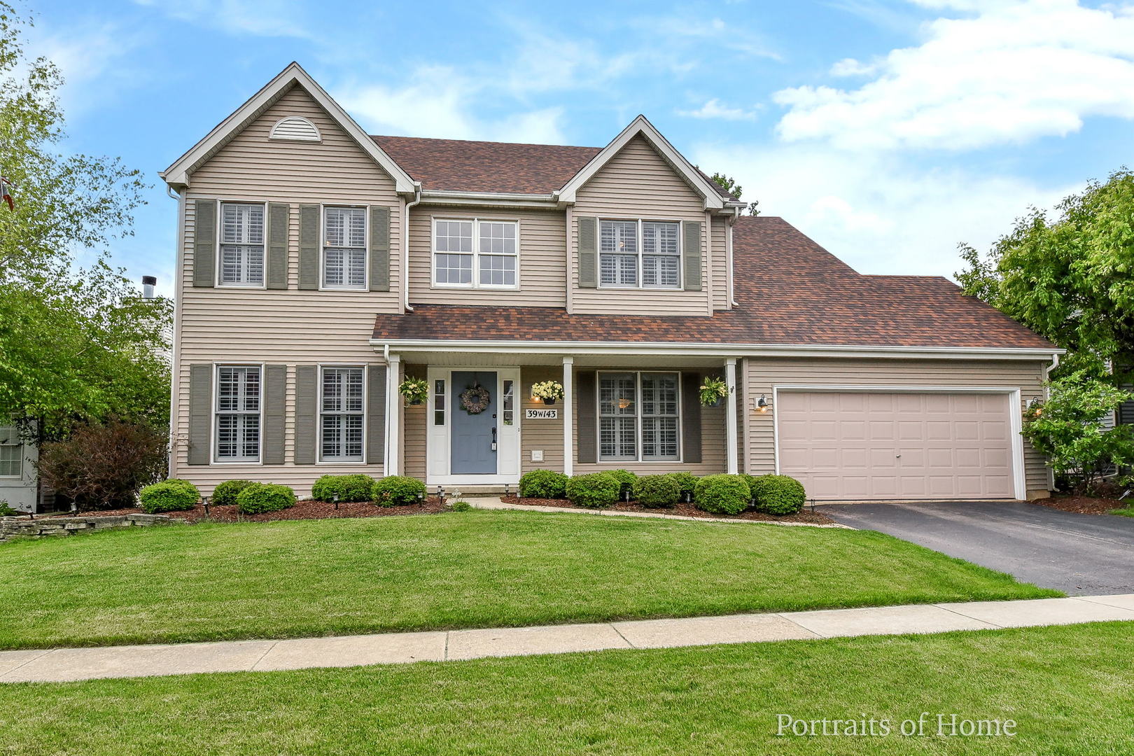 39W143 Bartelt Road Geneva, IL 60134 - Photo 1 of 21 a front view of a house with a garden and plants