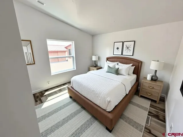 a bedroom with a bed and window