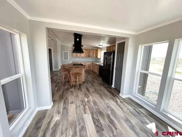 a view of a dining room with furniture window and wooden floor