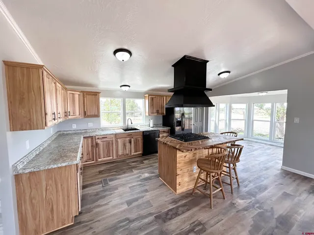 a kitchen with a table chairs a window and appliances