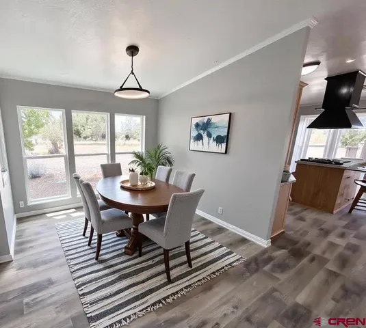 a view of a dining room with furniture window and wooden floor