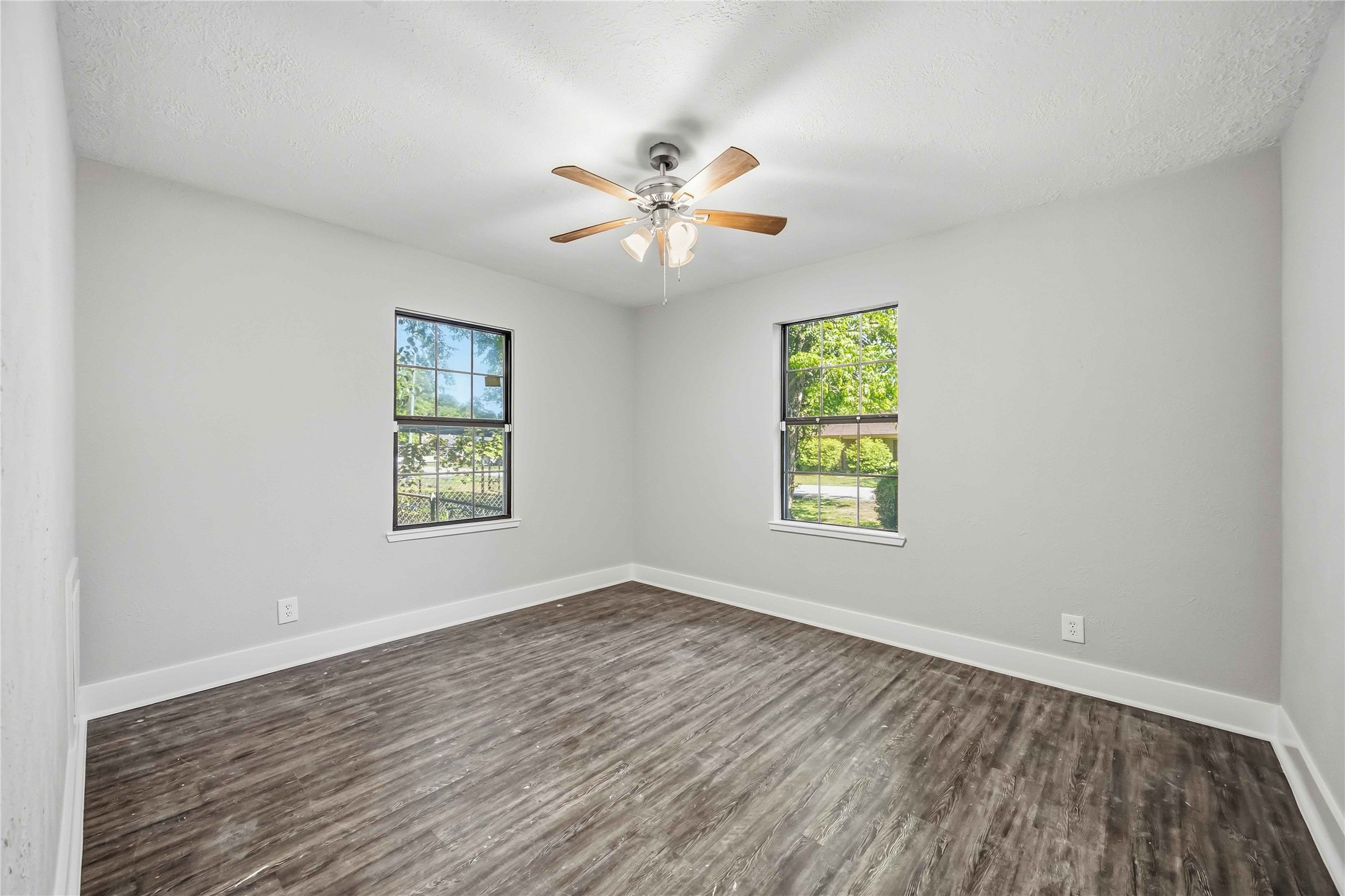 113 East Witcher Lane Houston, TX 77076 - Photo 17 of 21 a view of an empty room with window and wooden floor