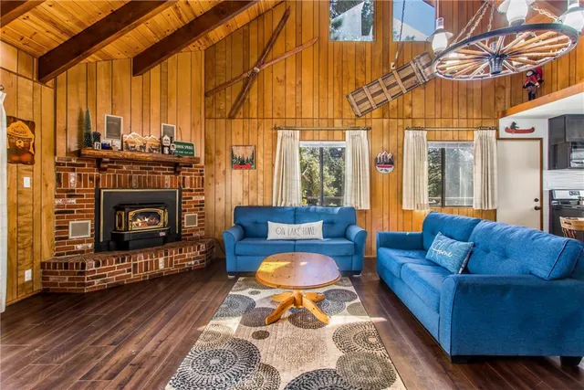 a living room with furniture a fireplace and a table