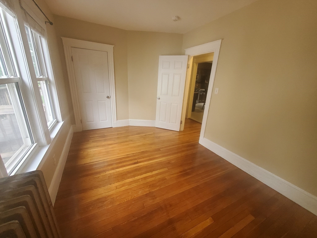 45 Intervale Street, Unit 2 Boston, MA 02121 - Photo 13 of 17 a view of an empty room with wooden floor and a window