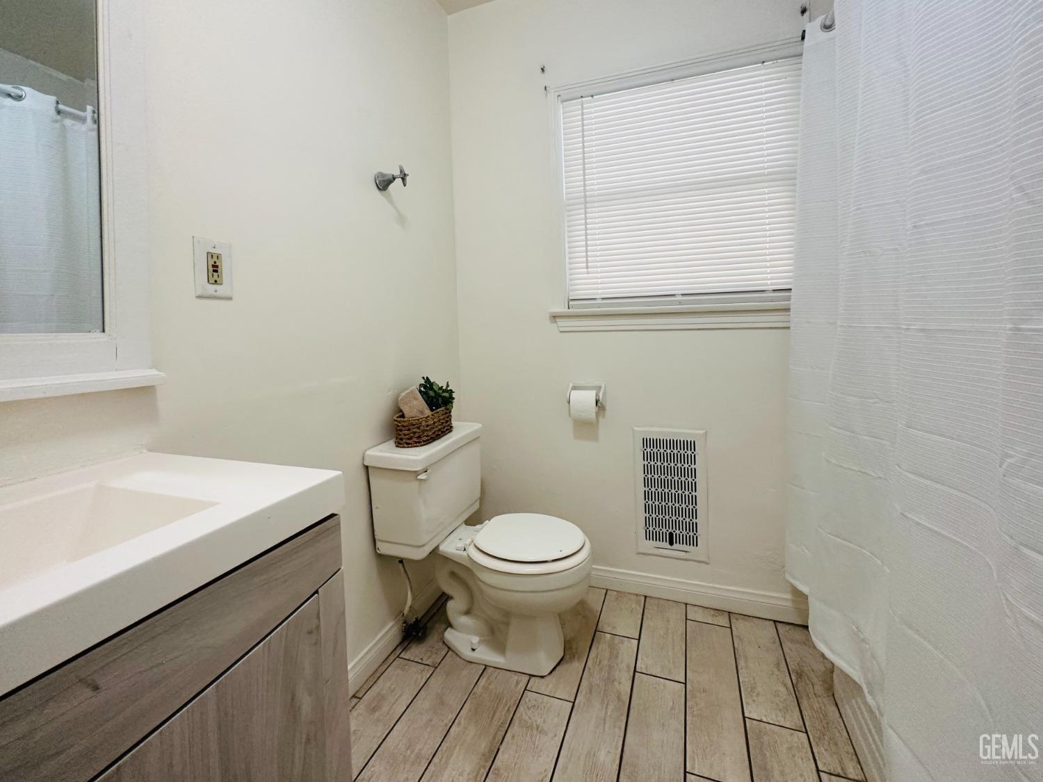 Undisclosed Address Bakersfield, CA 93308 - Photo 17 of 28 a bathroom with a sink a toilet and a window