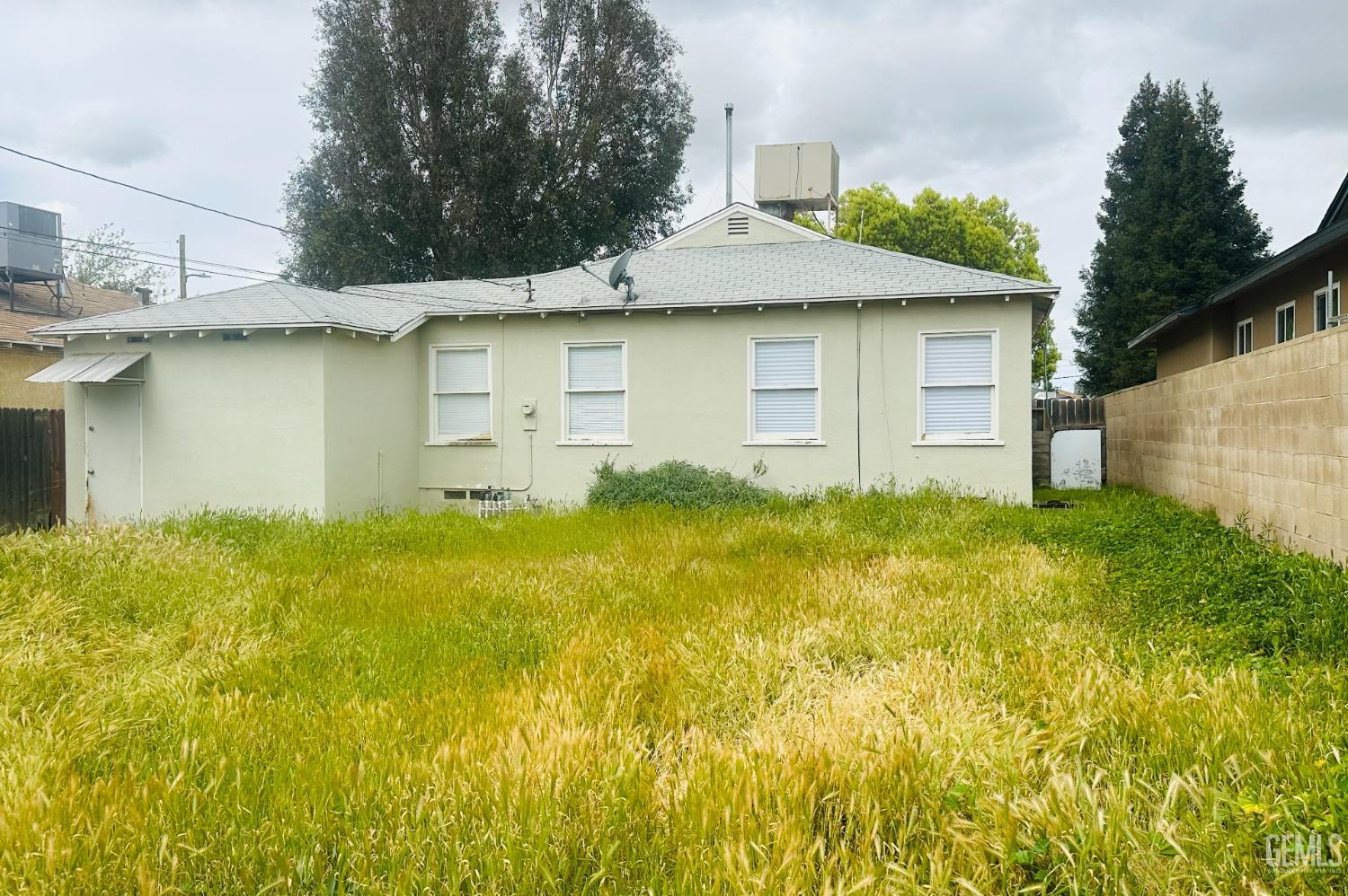 Undisclosed Address Bakersfield, CA 93308 - Photo 24 of 28 a front view of a house with a yard
