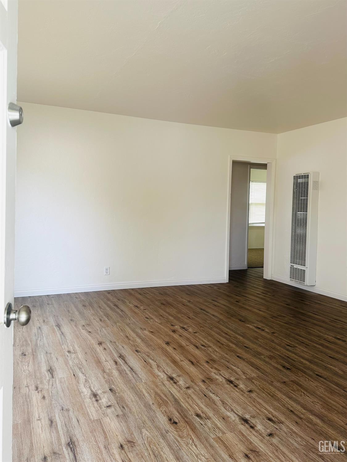 Undisclosed Address Bakersfield, CA 93308 - Photo 5 of 28 a view of an empty room and wooden floor