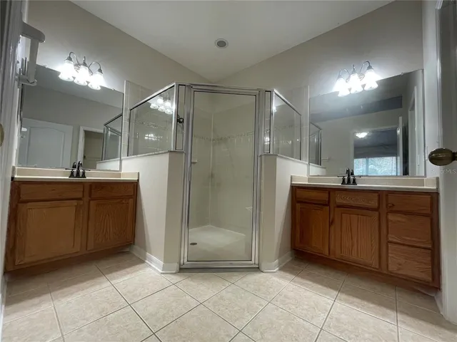 a bathroom with a sink a toilet a mirror and shower