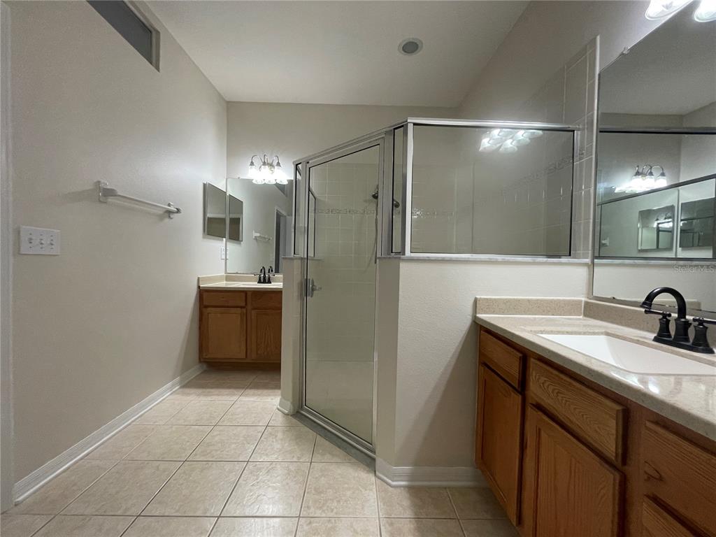 1228 Bensbrooke Drive Wesley Chapel, FL 33543 - Photo 15 of 37 a bathroom with a sink a toilet a mirror a vanity and shower
