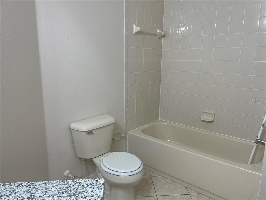 1228 Bensbrooke Drive Wesley Chapel, FL 33543 - Photo 17 of 37 a white toilet sitting next to a bath tub