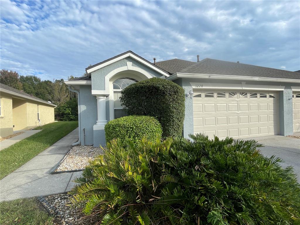 1228 Bensbrooke Drive Wesley Chapel, FL 33543 - Photo 2 of 37 a front view of a house with a yard