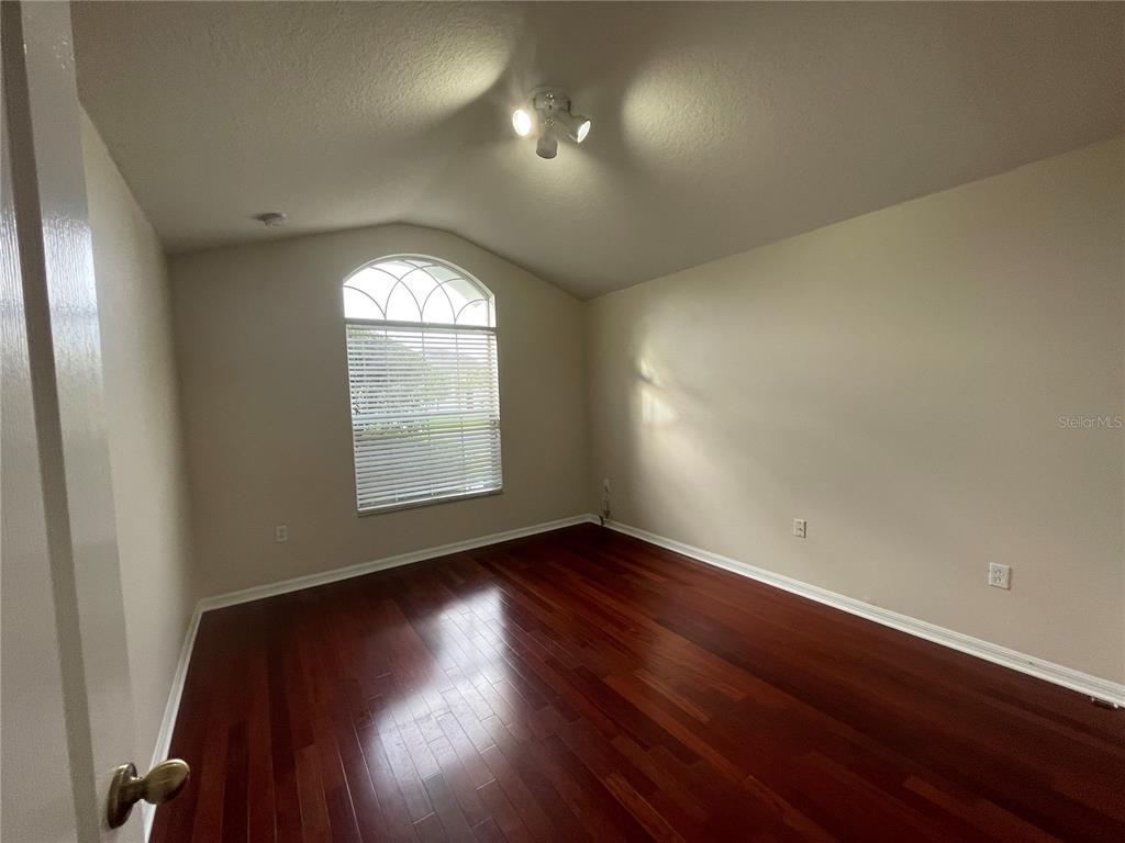 1228 Bensbrooke Drive Wesley Chapel, FL 33543 - Photo 10 of 37 an empty room with wooden floor and windows