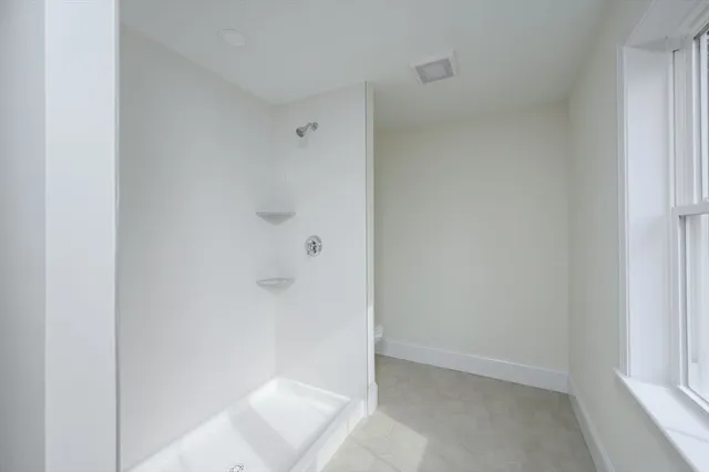 a bathroom with a sink a toilet and a shower